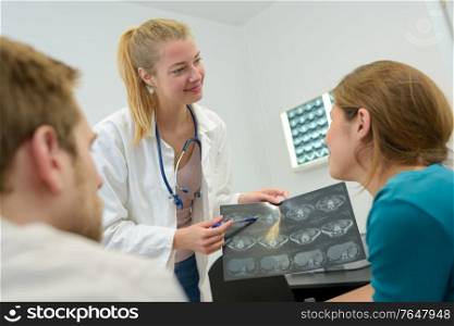 doctor man and woman talking and examining spine mri results