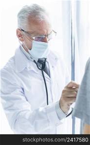 doctor mask examining crop patient
