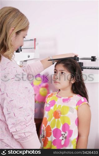 Doctor measure little child girl height growth