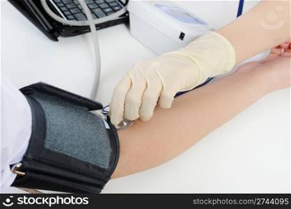 doctor measures the pressure of the patient in the clinic. Isolated on the white background