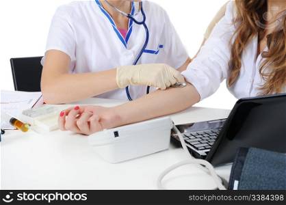 doctor measures the pressure of the patient in the clinic. Isolated on the white background