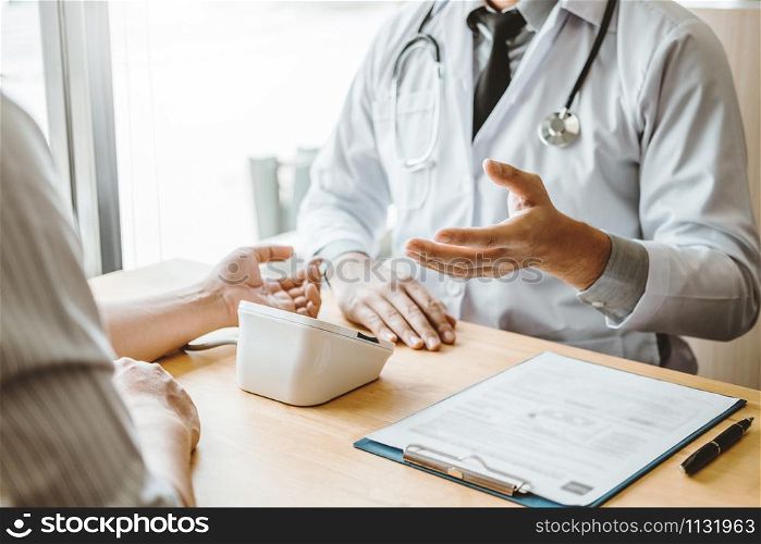 Doctor Measuring arterial blood pressure with man patient on arm Health care in hospital