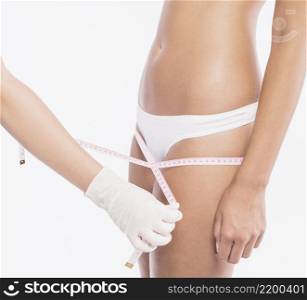 doctor measuring woman hips