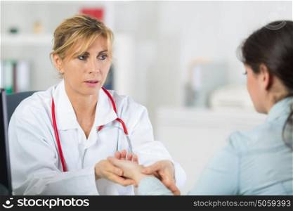 doctor messuring blood pressure of a patient