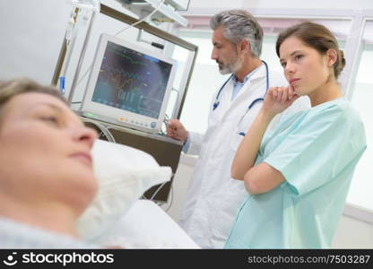 doctor monitoring patients heartbeat in hospital