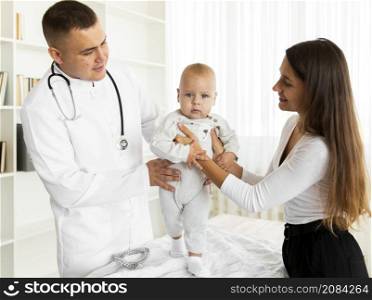 doctor mother helping baby walk