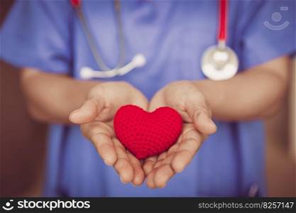 Doctor Nurse hand giving red heart for help care or blood donation healthcare share love to fight disease concept.