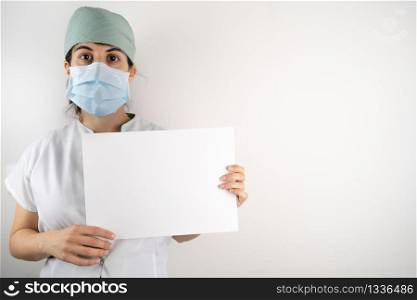 Doctor nurse showing a sign with face mask
