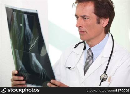 Doctor observing hand x-ray