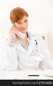 Doctor office - female physician make phone call sit by desk
