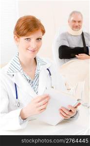 Doctor office - portrait female physician read book senior patient