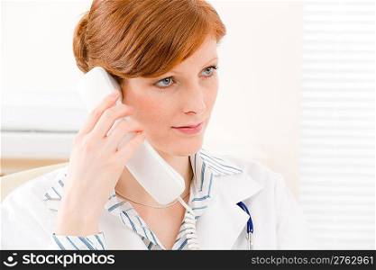 Doctor office - portrait of female physician make phone call