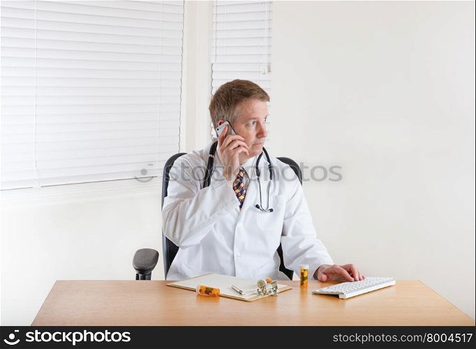 Doctor on phone while working in office