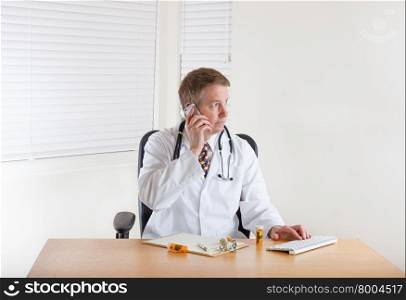 Doctor on phone while working in office