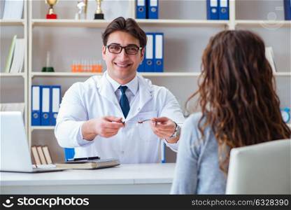 Doctor optician prescribing glasses to a patient