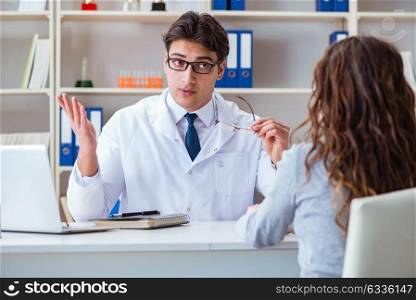 Doctor optician prescribing glasses to a patient