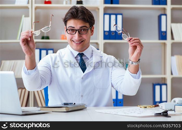 Doctor optician prescribing holding optical glasses