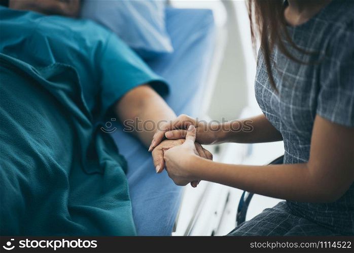 Doctor or nurse holding elderly lady&rsquo;s hands.