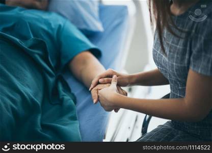 Doctor or nurse holding elderly lady&rsquo;s hands.