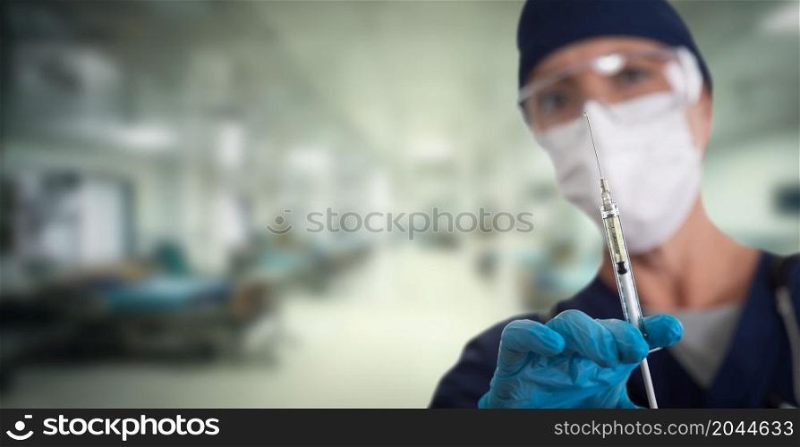 Doctor or Nurse Holding Medical Syringe with Needle Within Hospital.
