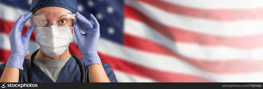 Doctor or Nurse Wearing Medical Personal Protective Equipment (PPE) Against The American Flag Banner.