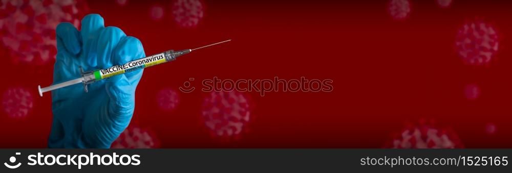 Doctor or Nurse Wearing Surgical Glove Holding Medical Syringe with Coronavirus COVID-19 Vaccine Label Banner of Cells.
