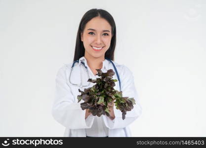 Doctor or nutritionist holding fresh vegetables and smile in the clinic. A healthy diet, the concept of nutrition food as a prescription for good health, vegetables is medicine