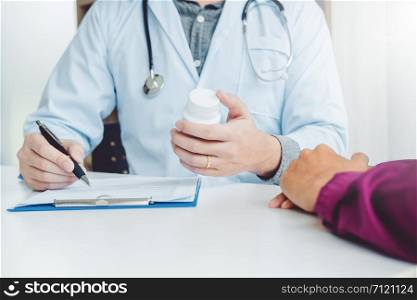 Doctor or physician recommend pills medical prescription to male Patient