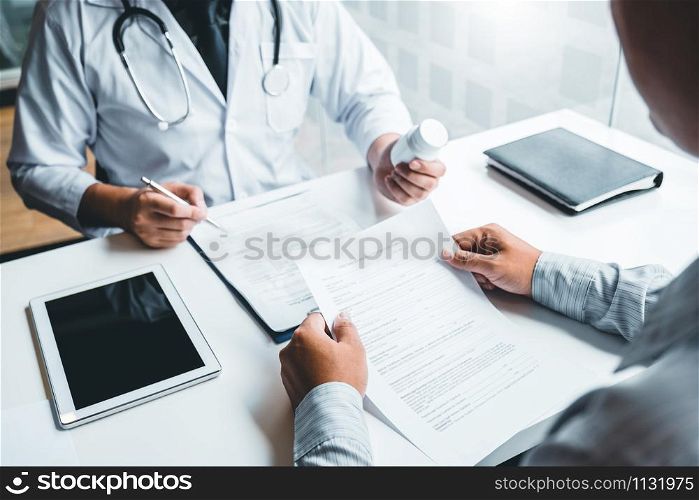 Doctor or physician recommend pills medical prescription to male Patient hospital and medicine concept