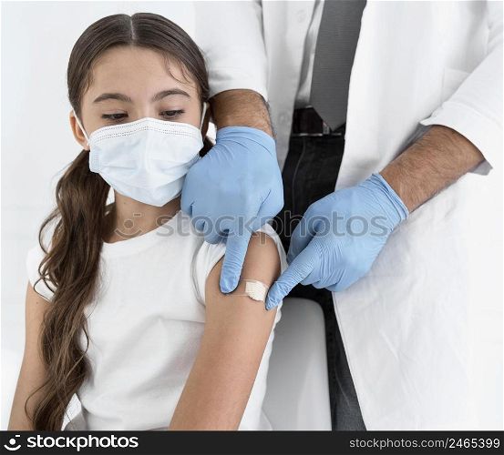 doctor placing bandage little girl s arm