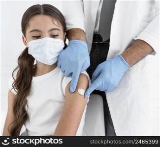 doctor placing bandage little girl s arm