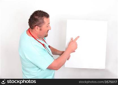Doctor pointing to a blank sign