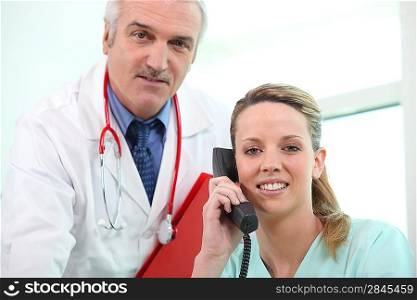 Doctor posing with his assistant