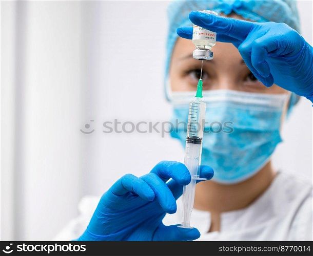 Doctor prepares a syringe with an injection, close-up. Doctor prepares a syringe