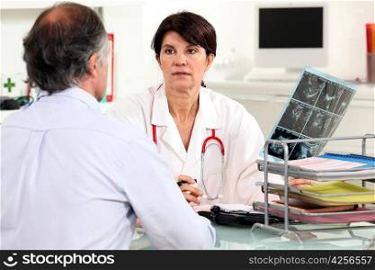 Doctor presenting x-ray results to patient