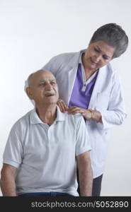 Doctor pressing old mans shoulder