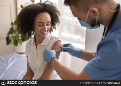 doctor putting patch patient arm after vaccination