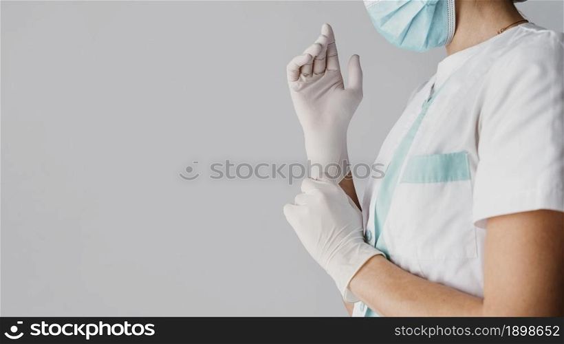 doctor putting surgical gloves with copy space. Resolution and high quality beautiful photo. doctor putting surgical gloves with copy space. High quality beautiful photo concept