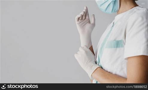 doctor putting surgical gloves with copy space. Resolution and high quality beautiful photo. doctor putting surgical gloves with copy space. High quality beautiful photo concept
