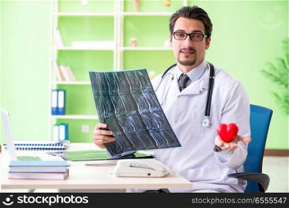 Doctor radiologist looking at x-ray scan in hospital