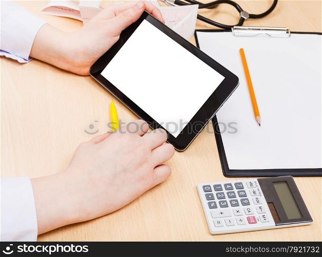 doctor read from tablet pc with cut out screen during appointment