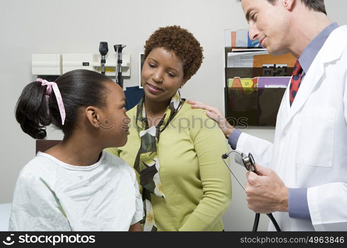 Doctor reassuring mother and daughter