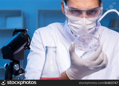 Doctor researching new virus in lab at night