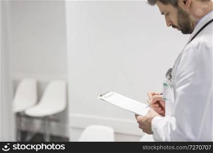 Doctor reviewing medical report at hospital