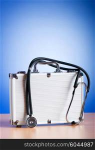 Doctor&rsquo;s case with stethoscope against colorful background