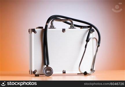 Doctor&rsquo;s case with stethoscope against colorful background