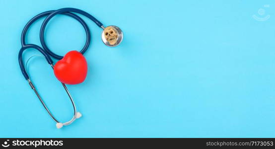 Doctor&rsquo;s Day concept, flat lay top view, stethoscope with red hearts diagnosis of heart disease on blue background with copy space for text