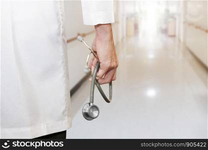 doctor's hand holding stethoscope in the hospital