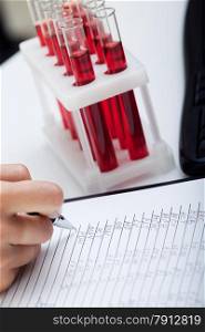 Doctor&rsquo;s medical notes with background of blood samples