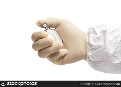 doctor’s hand in white surgical medical gloves holds and white coverall suit an activated mechanical stopwatch.. doctor’s hand in white surgical medical gloves holds and white coverall suit an activated mechanical stopwatch